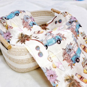 alt="Sunny Voyage Bamboo Swaddle Malaysia – tropical baby blanket with surf and sun style"